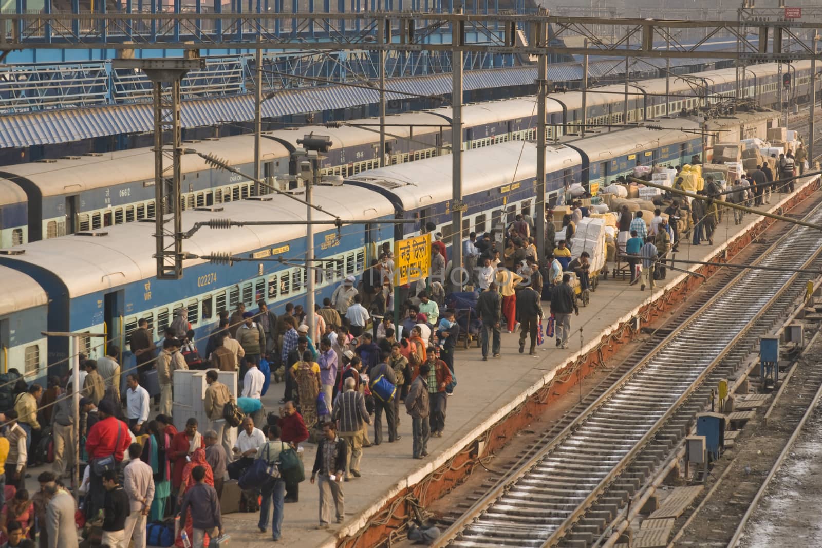 Crowded platform and trains at New Delhi railway station in Delhi, India