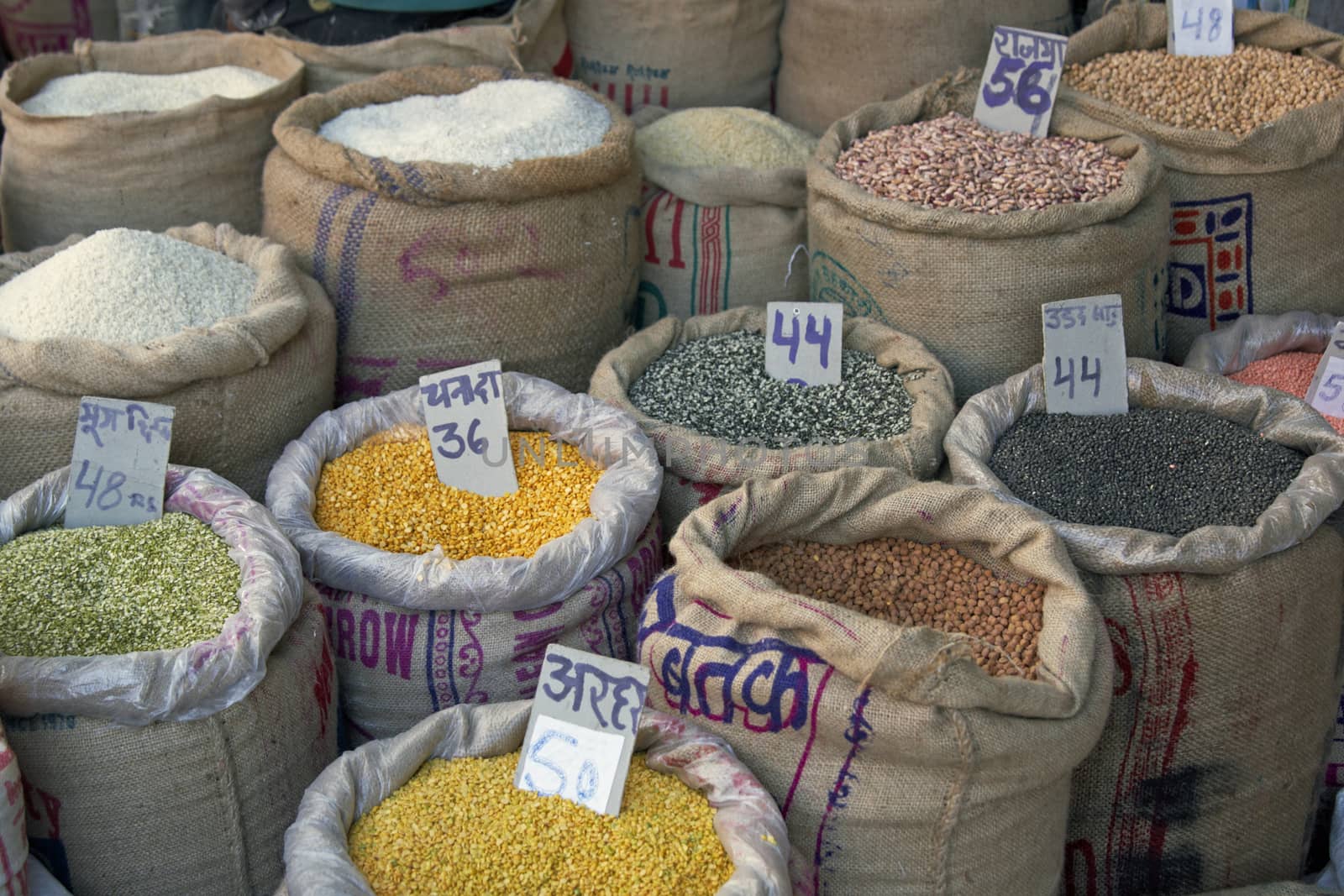 Sacks of pulses, rice and grain outside a shop in Old Delhi, India