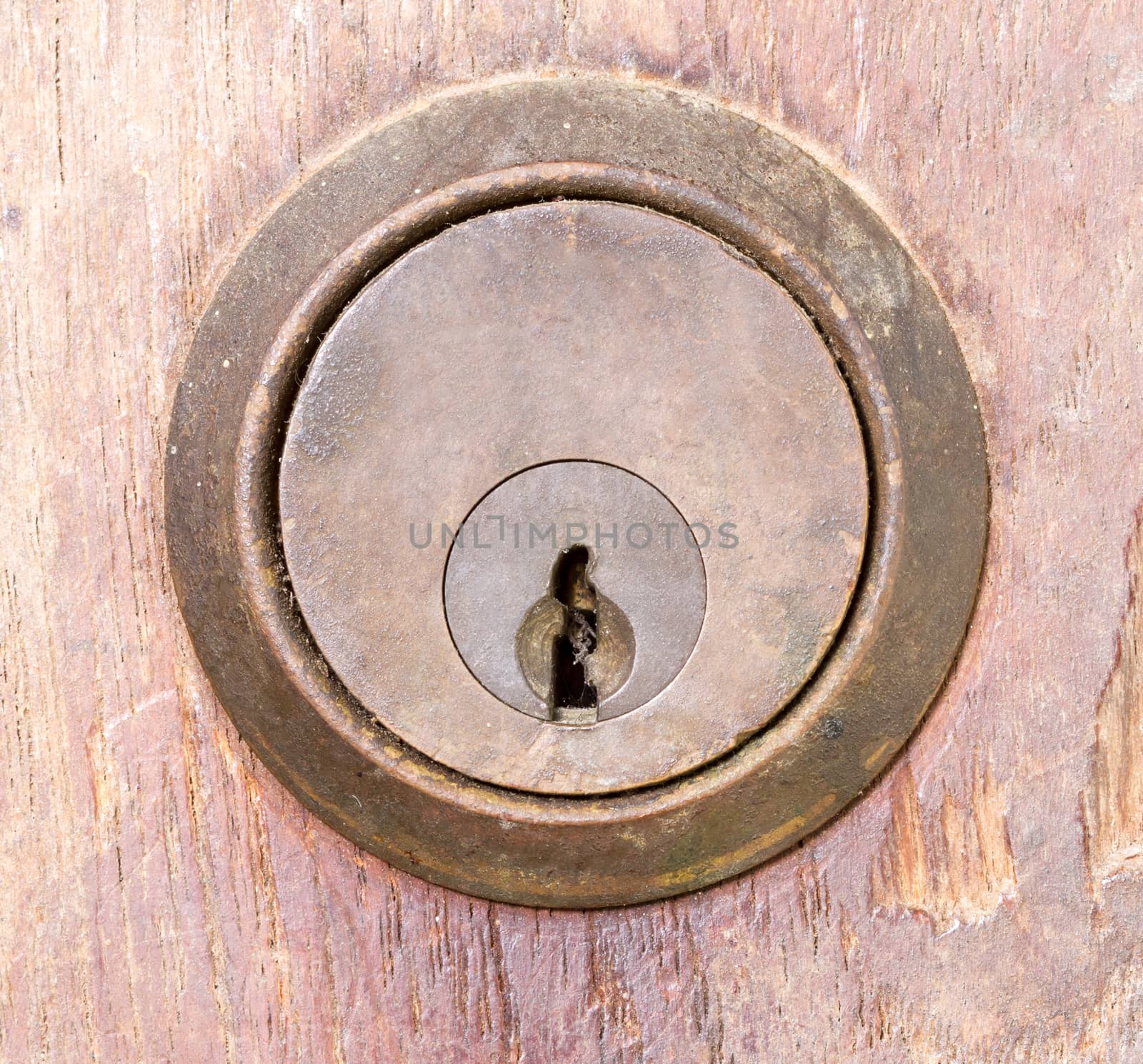 rounded aged keyhole on wooden wall - closed up