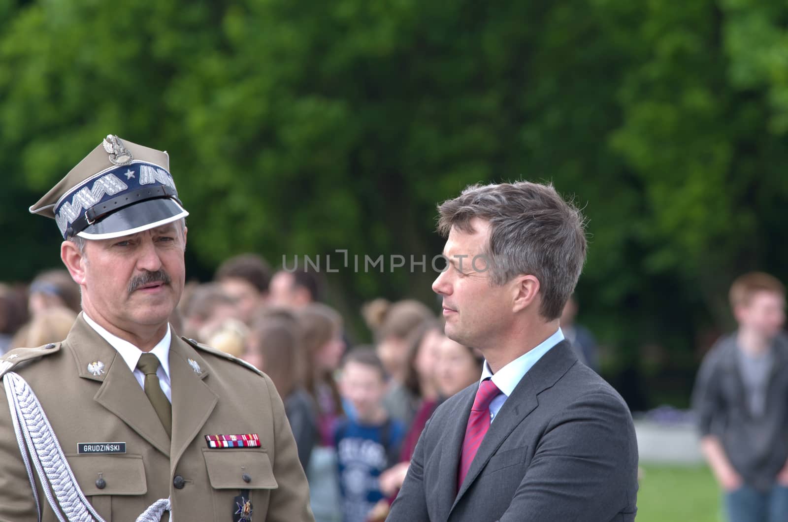 Warsaw, Poland - May 12, 2014: Danish Crown Prince Couple on state visit to Poland. Crown Prince Frederik talks with Polish general after the wreath laying ceremony.