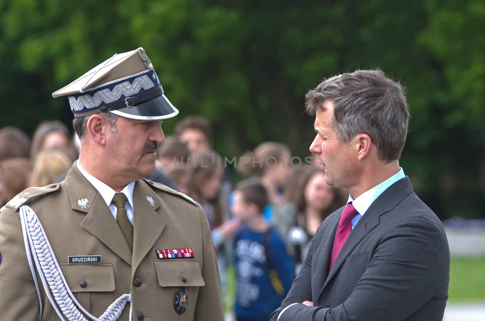 Warsaw, Poland - May 12, 2014: Danish Crown Prince Couple on state visit to Poland. Crown Prince Frederik talks with Polish general after the wreath laying ceremony.