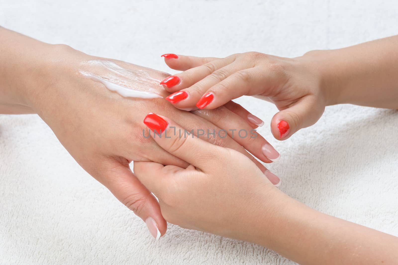 beauty salon, applying moisturizing cream onto the hands and massaging