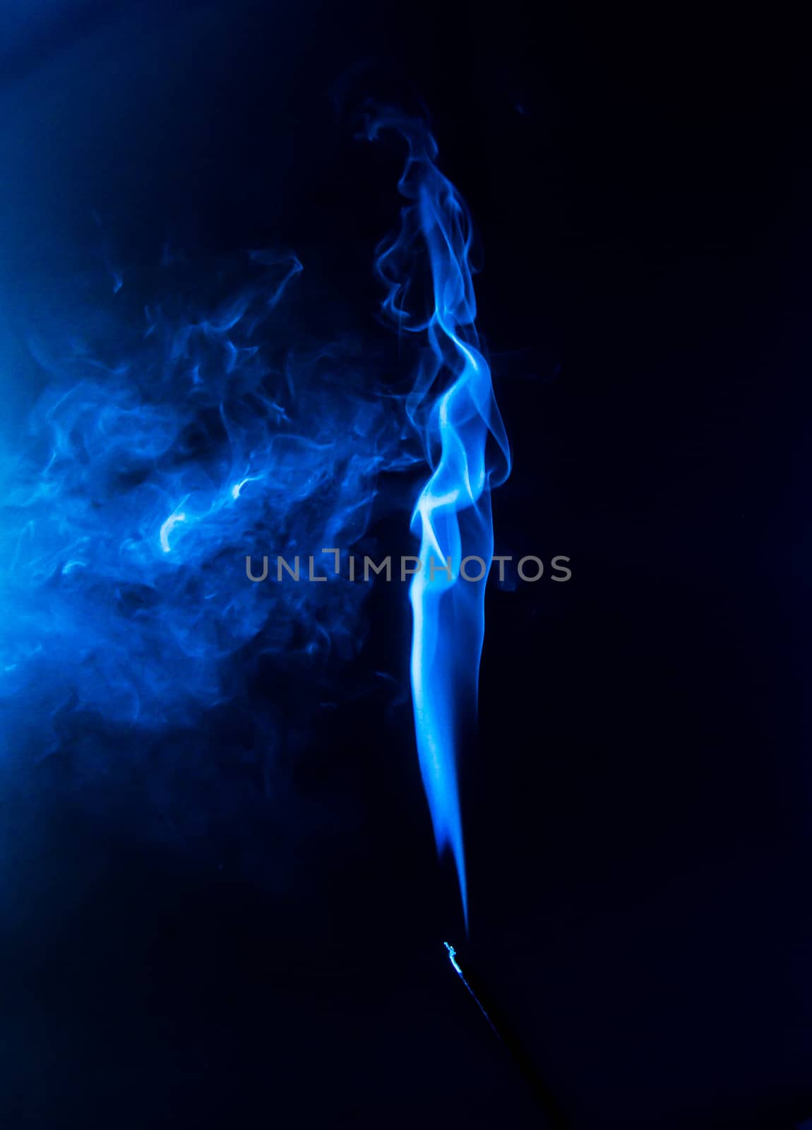 Flowing blue smoke on a black background. Isolated