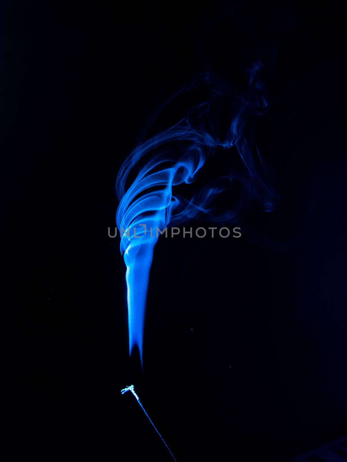 Flowing blue smoke on a black background. Isolated