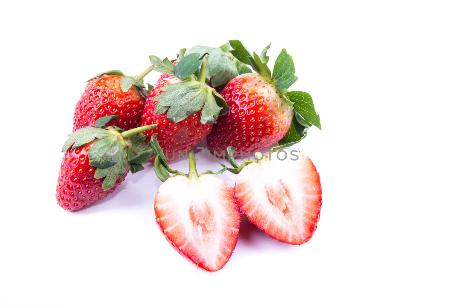 beautiful fresh strawberry with green leaves on the white background