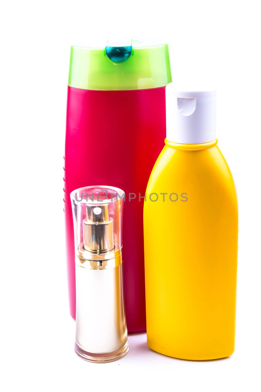 the colorful lotion bottles on the white background ideal for health care product purposes