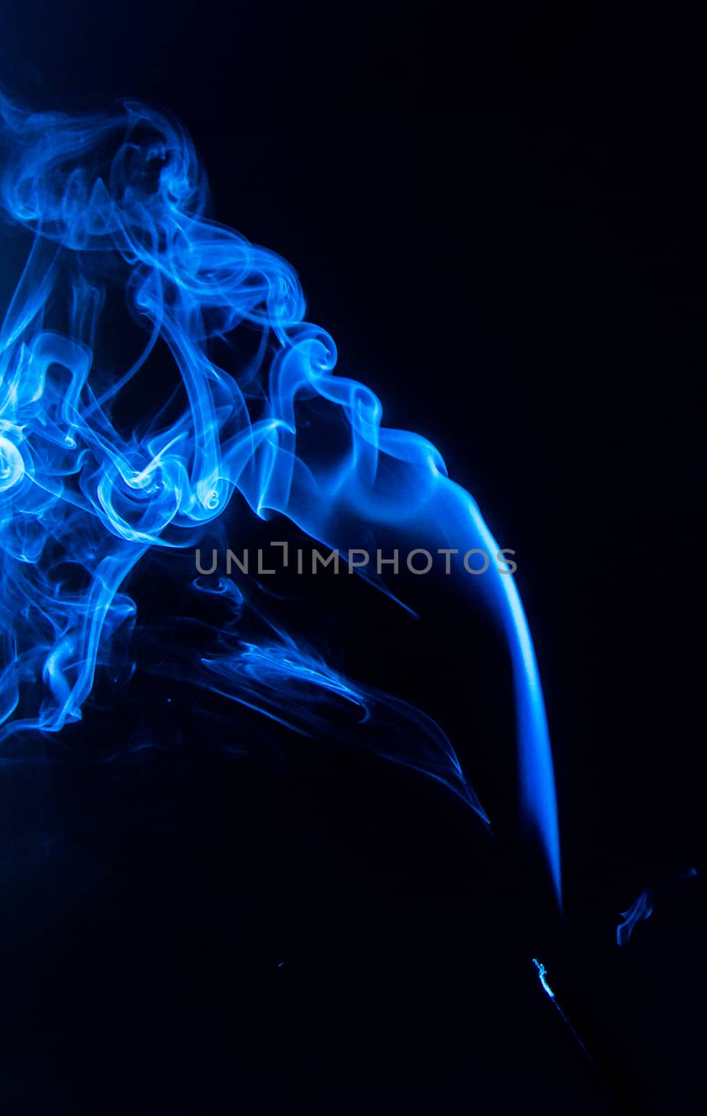 Flowing blue smoke on a black background. Isolated