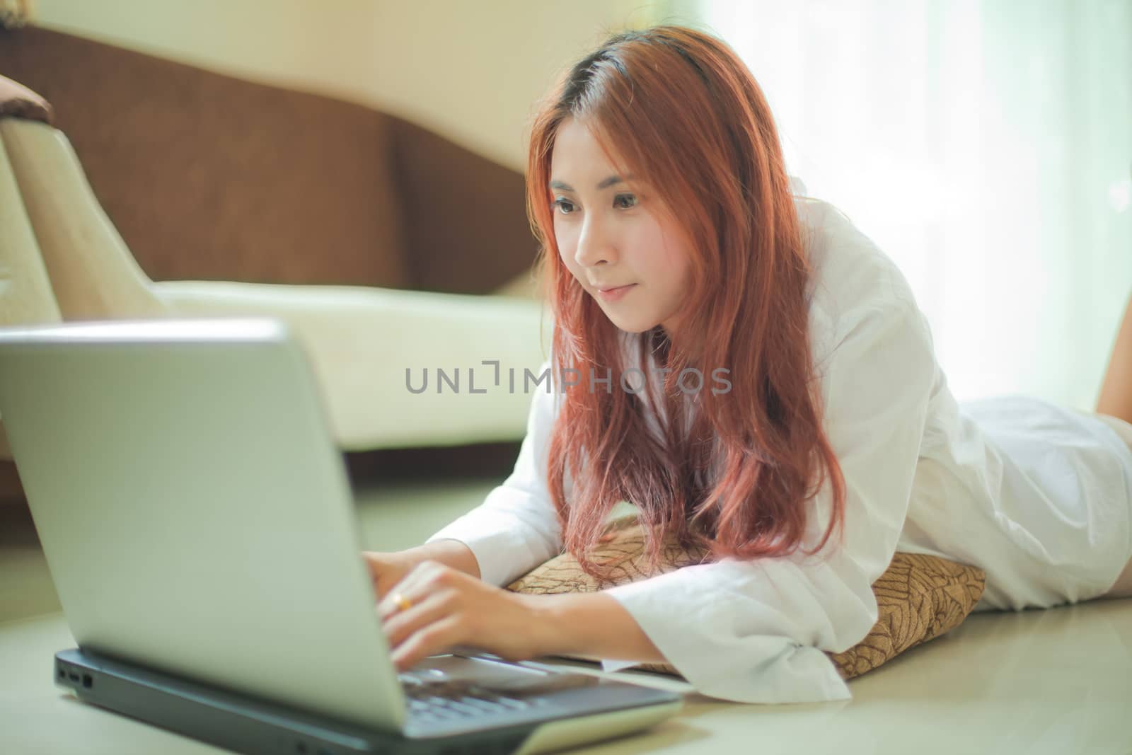 Woman using a laptop by witthaya