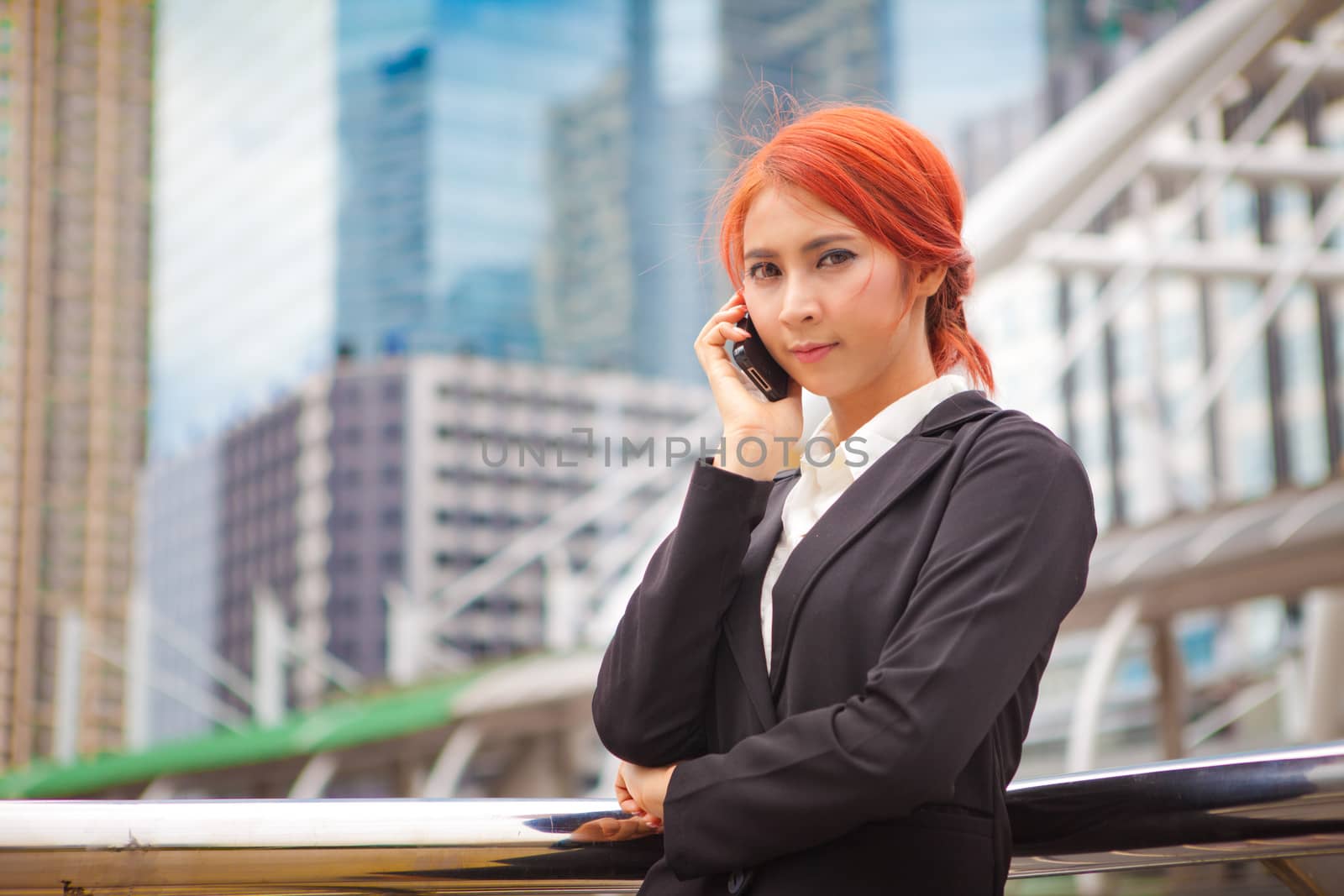 Young business asian woman calling on the phone at modern city