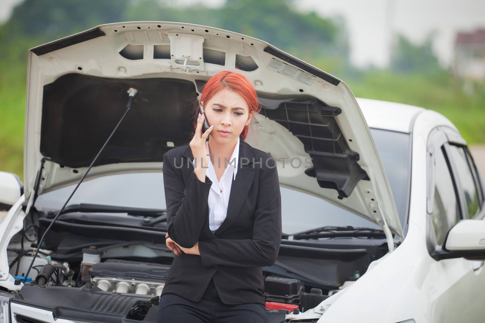 Young beautiful business asian woman with car broke down