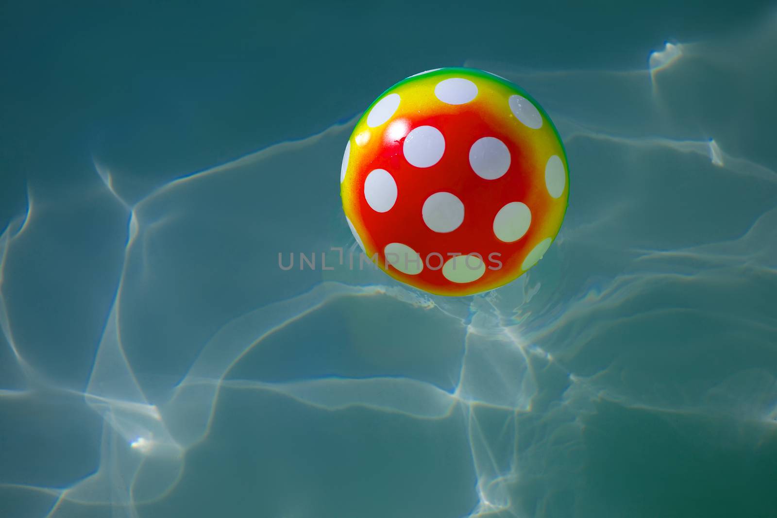 Rubber ball with spots in water
