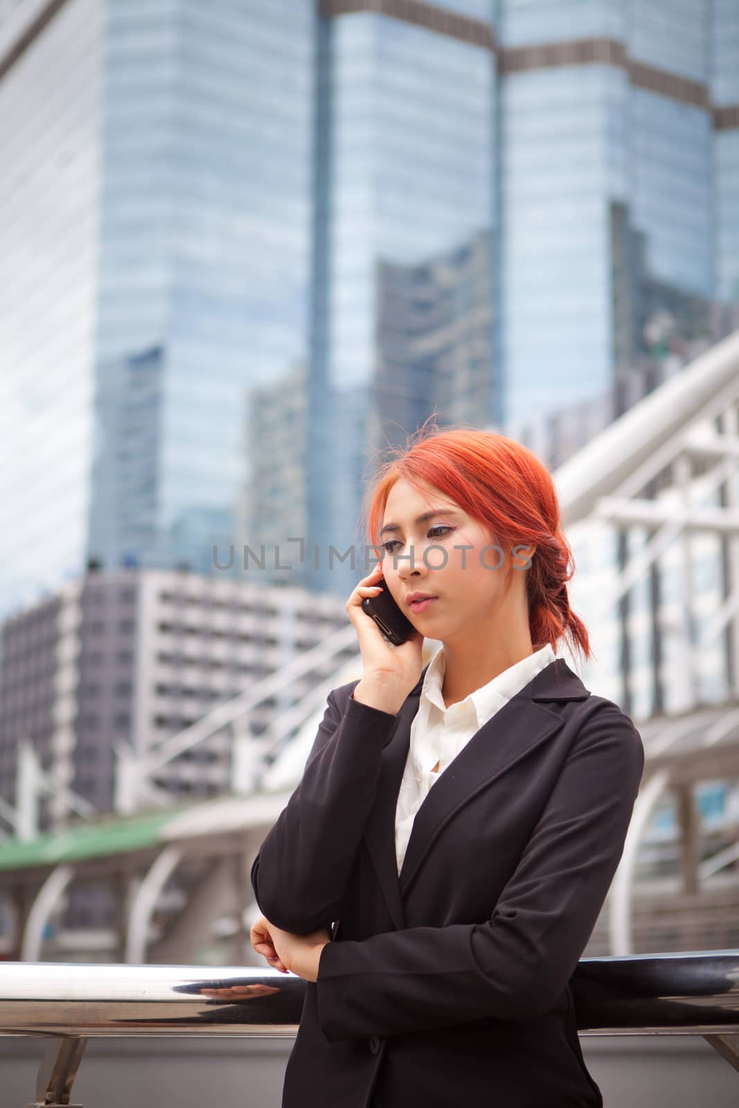 Young business asian woman calling on the phone at modern city