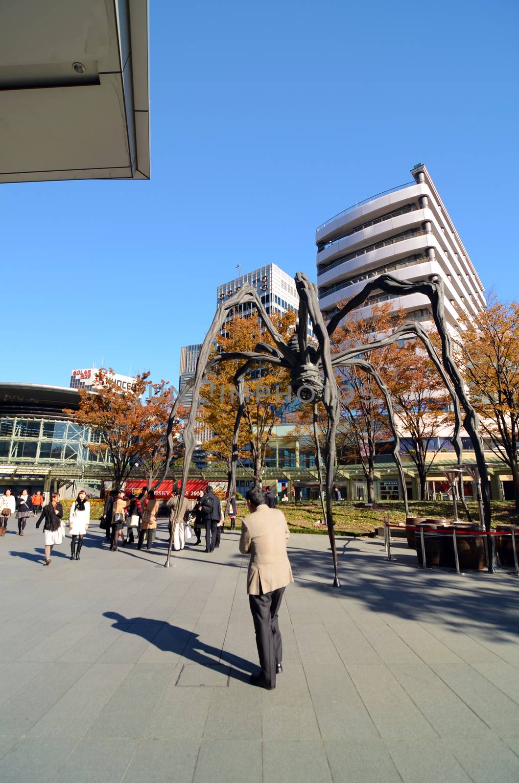 TOKYO, JAPAN - NOVEMBER 23: People visit the spider sculpture outside of Mori Tower in Roppongi Hills on September 18, 2013 in Tokyo, Japan.