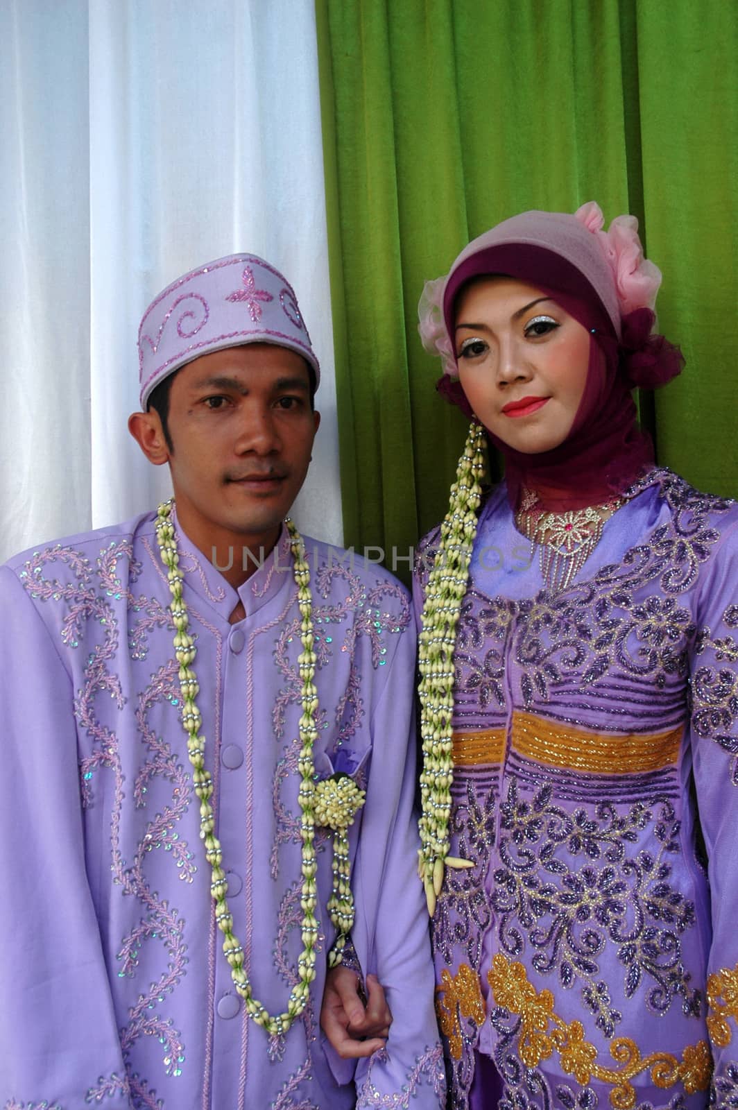 cikijing, west java, indonesia - july 10, 2011: bride and groom wearing traditional west java wedding costume
