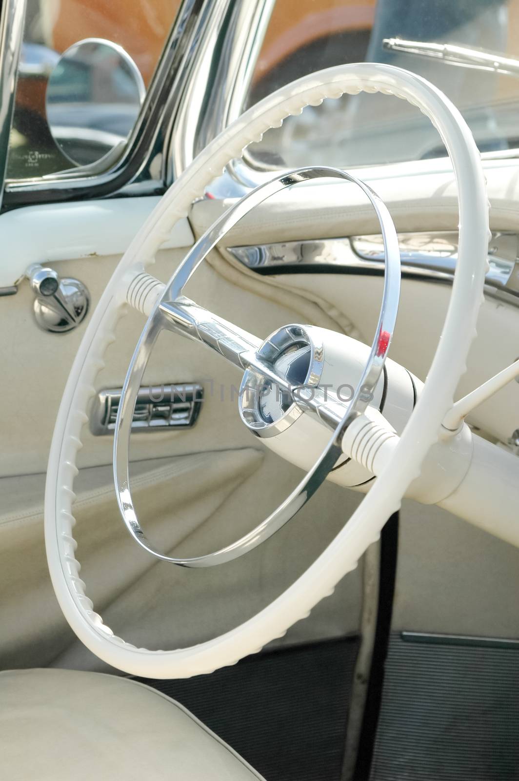 white steering wheel from a classic car, circa 1950