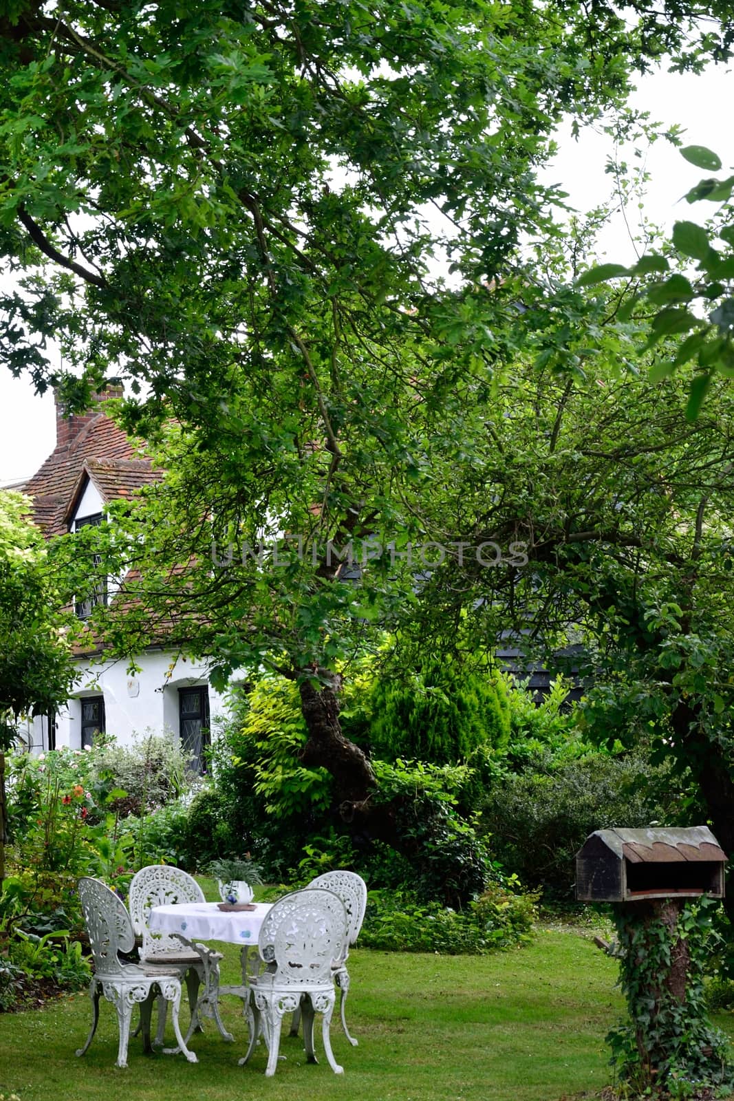 White iron table and chairs in english garden