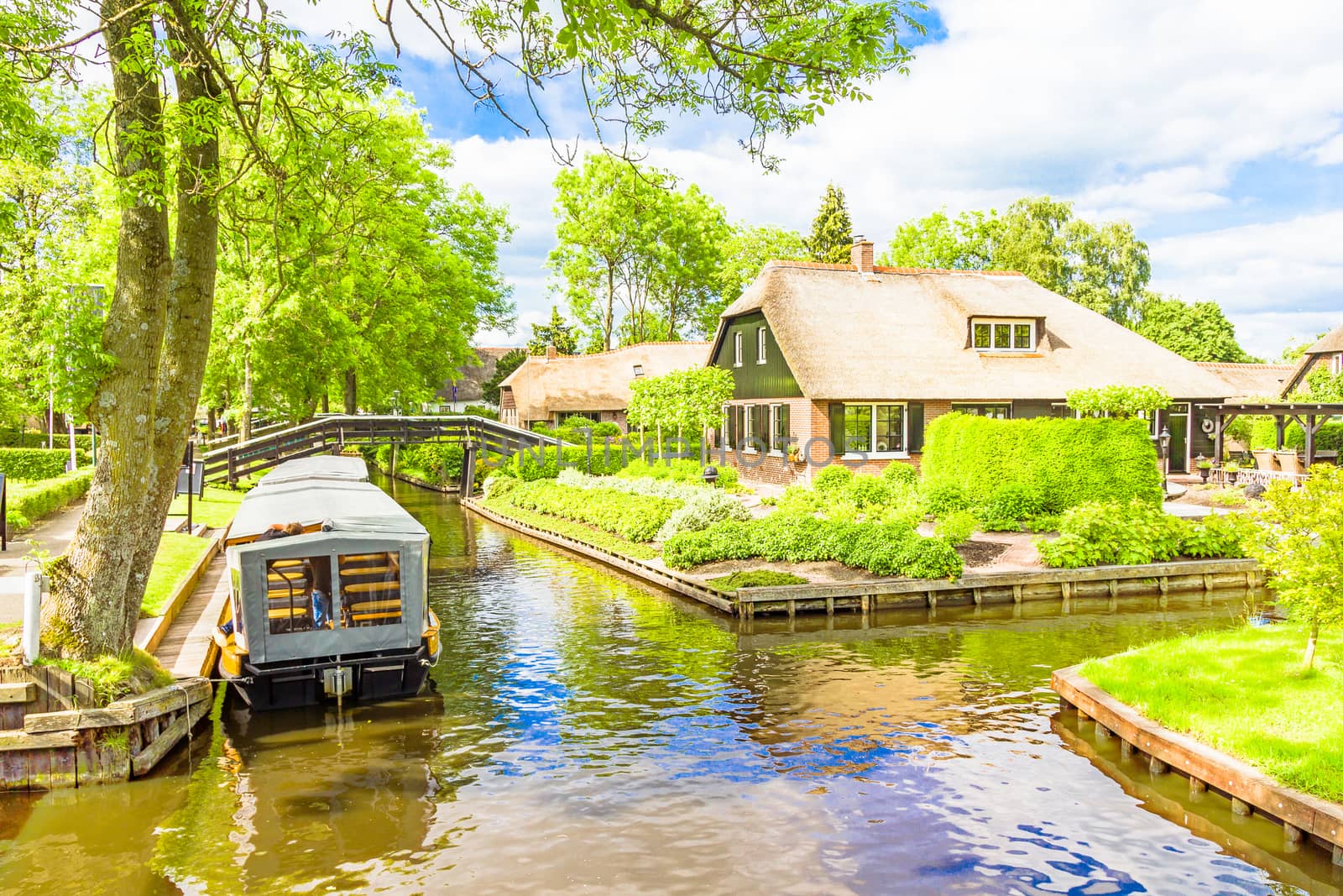 Typical Dutch houses and gardens in Giethoorn, The Netherlands by gianliguori
