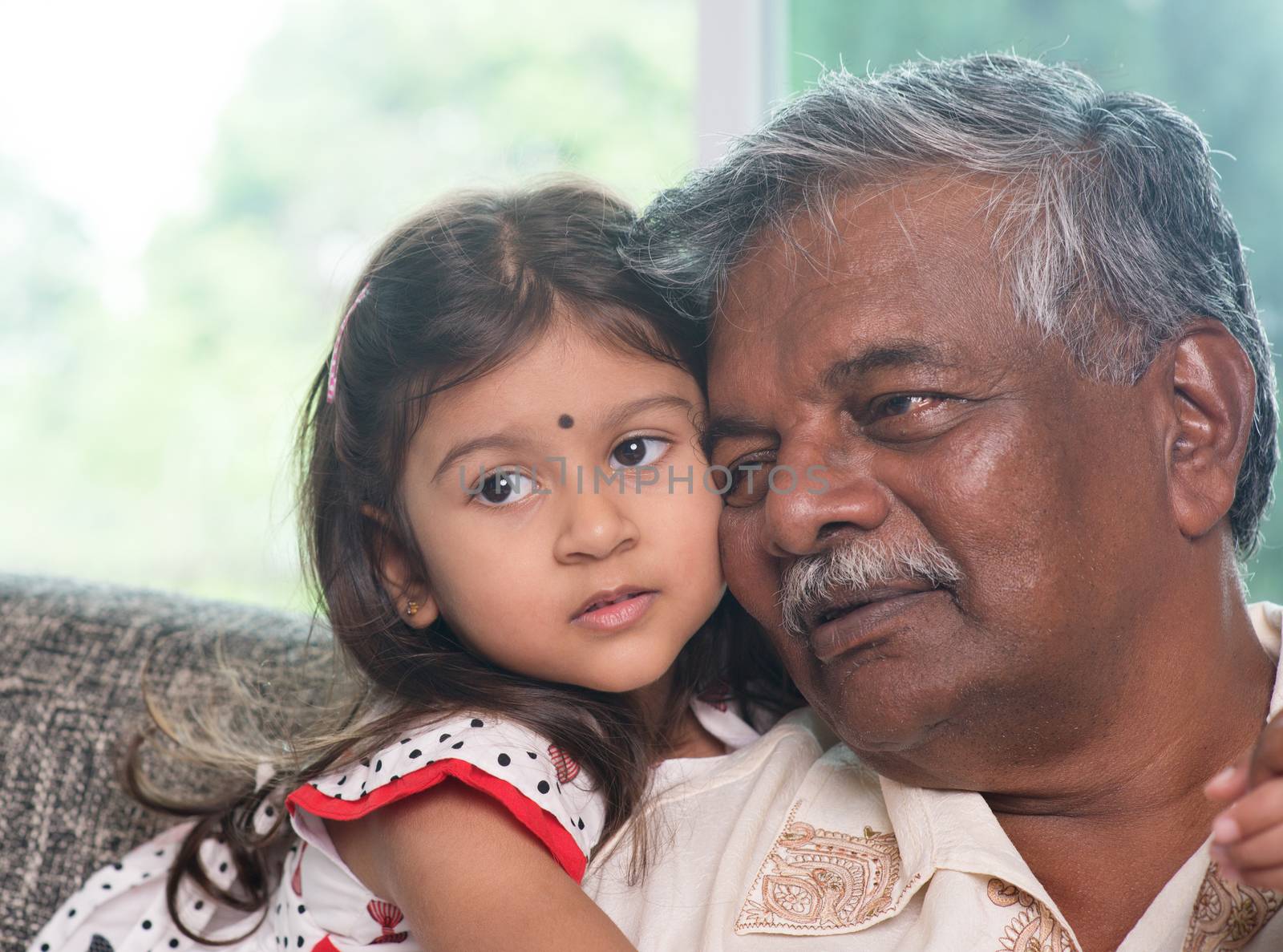 Portrait Indian family at home. Grandparent and grandchild close up face. Asian people living lifestyle. Grandfather and granddaughter.