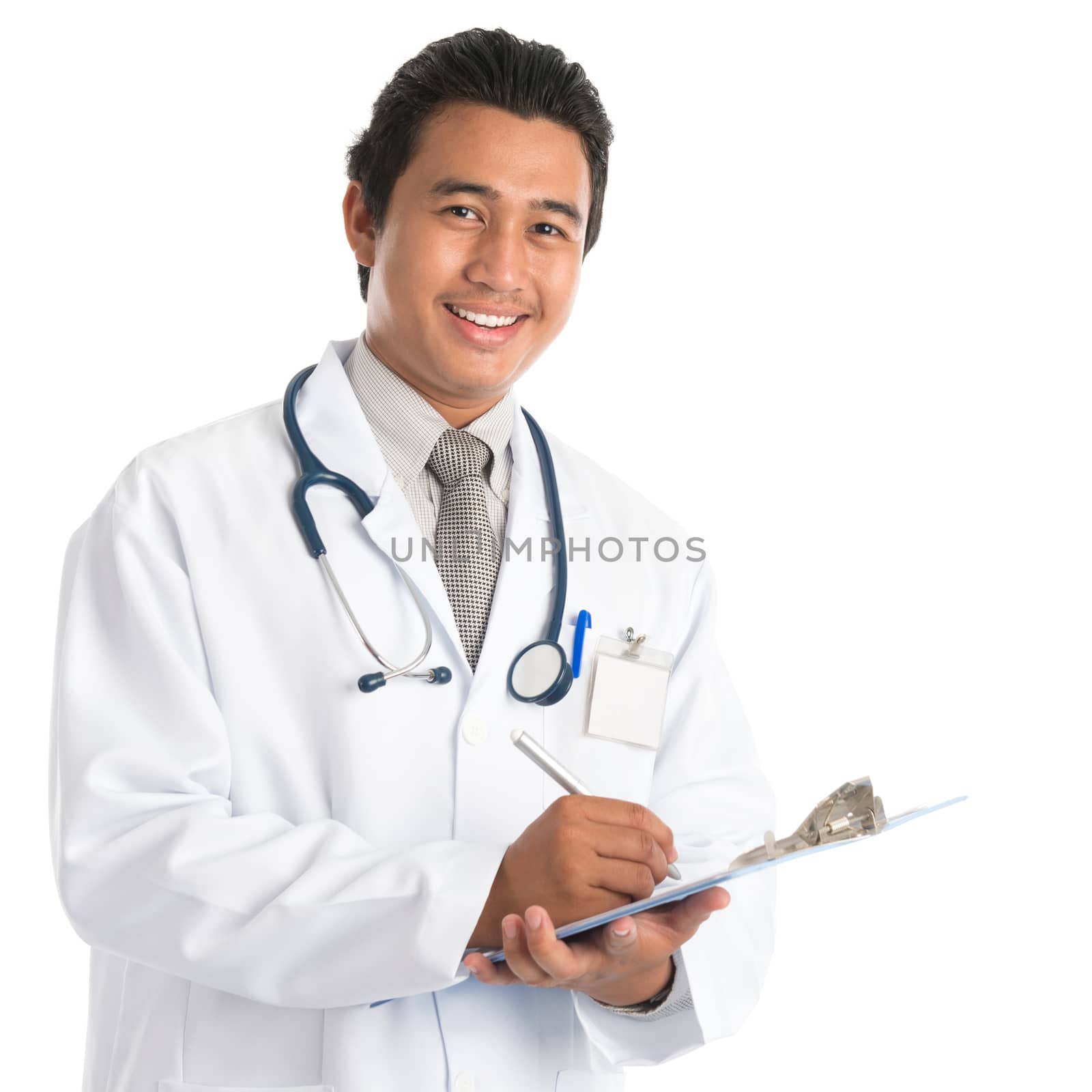 Portrait of southeast Asian male doctor writing medical report, standing isolated on white background. Young man model.