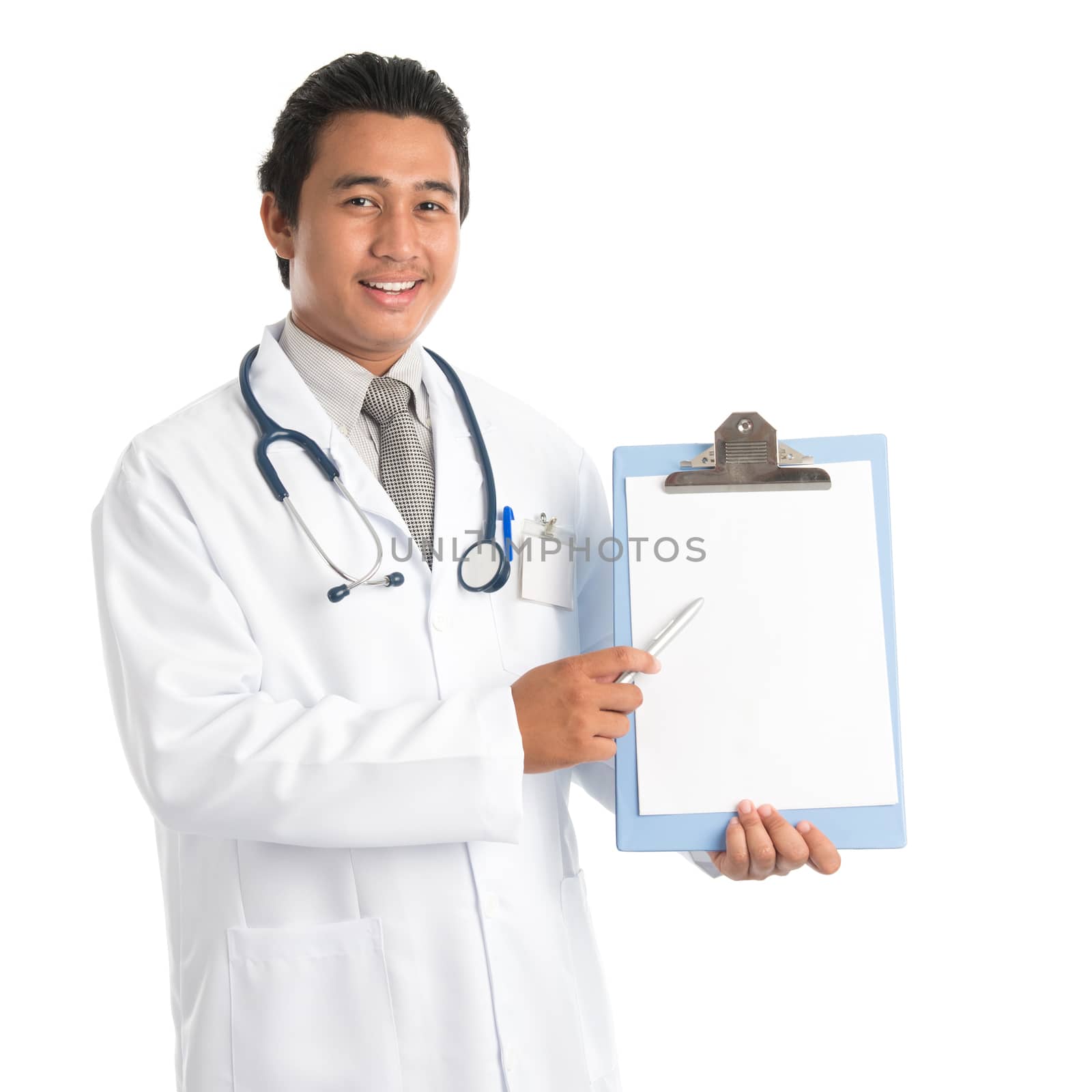 Portrait of southeast Asian male medical doctor showing and pointing to a blank empty clip file with space , standing isolated on white background. Young man model.