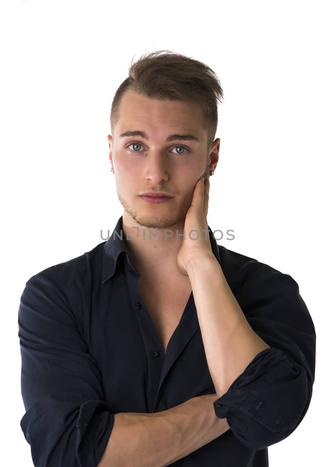 Serious confident blond young man with blue shirt looking at camera