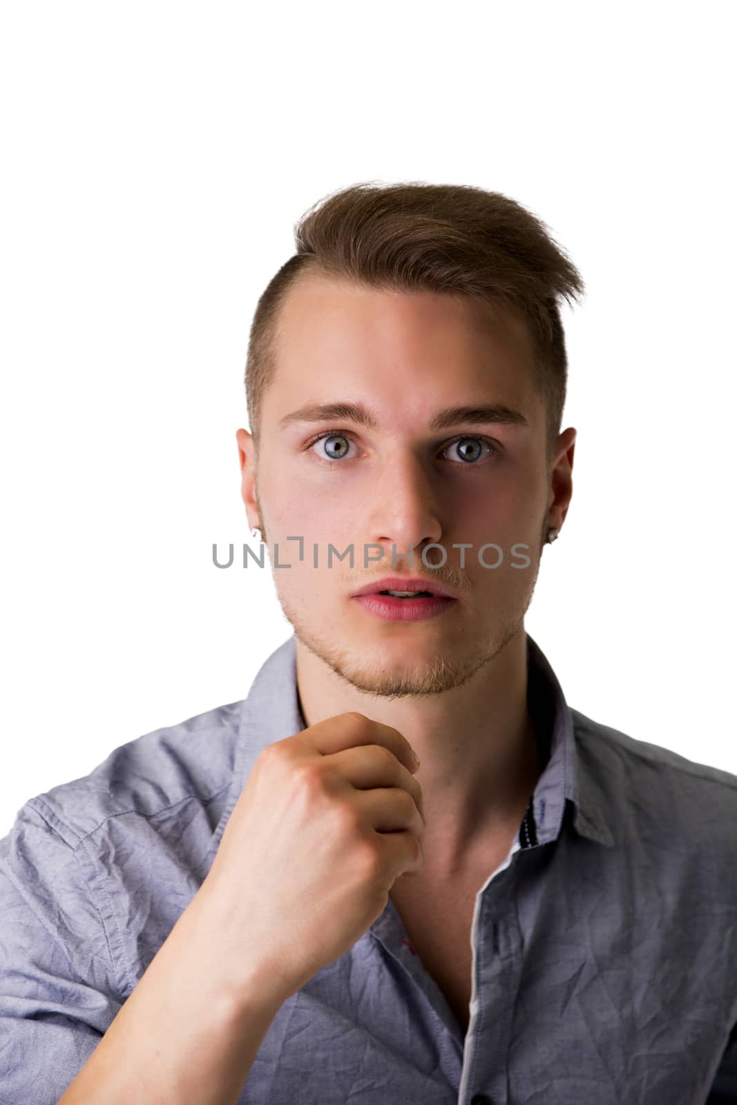 Handsome young man with aggressive, challenging expression, isolated on white