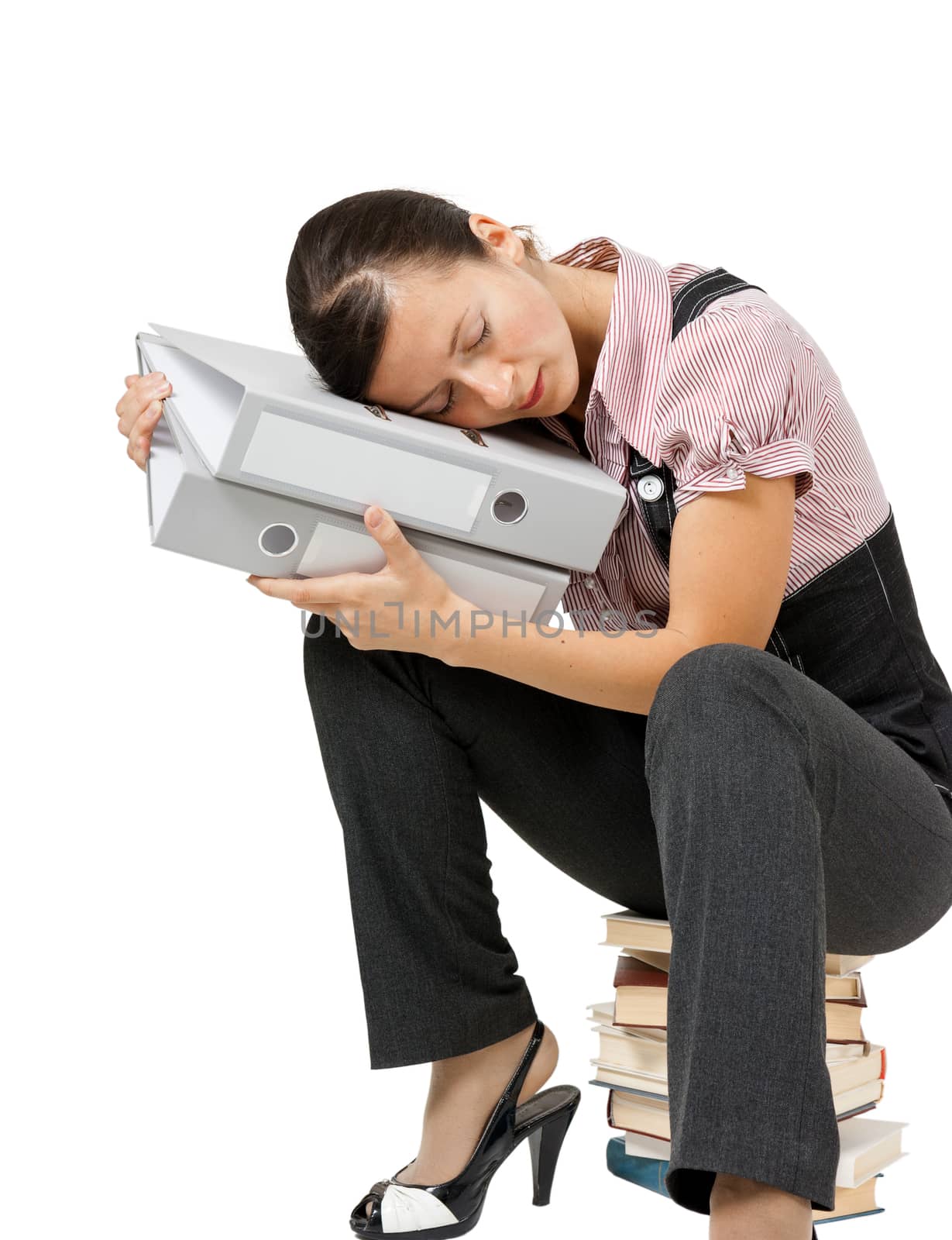 Young woman sleeping on the books. Tired office worker