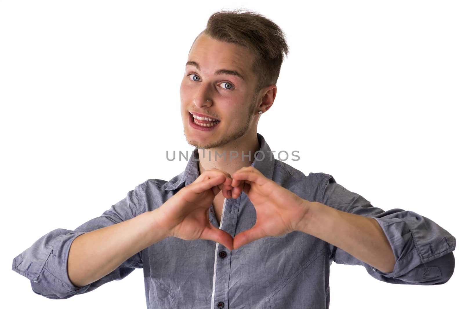 Happy blond young man doing heart or love sign with hands isolated on white