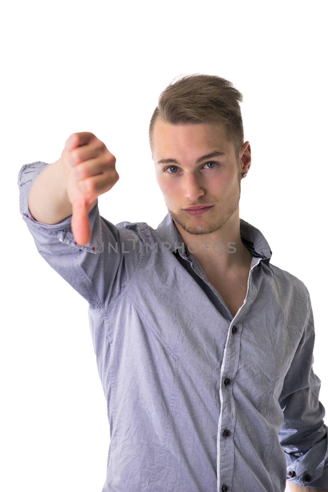 Handsome blond young man doing thumb down sign, isolated on white