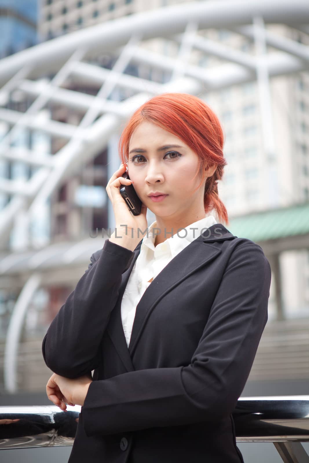 Young business asian woman calling on the phone at modern city