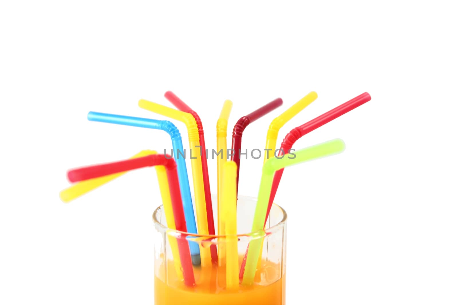 In a glass of juice a lot of multicolored tubules