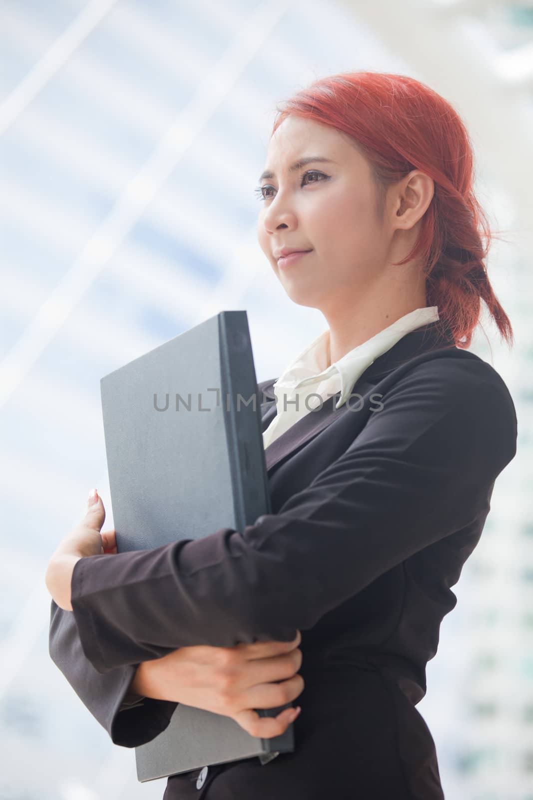 Young business asian woman with document at modern city