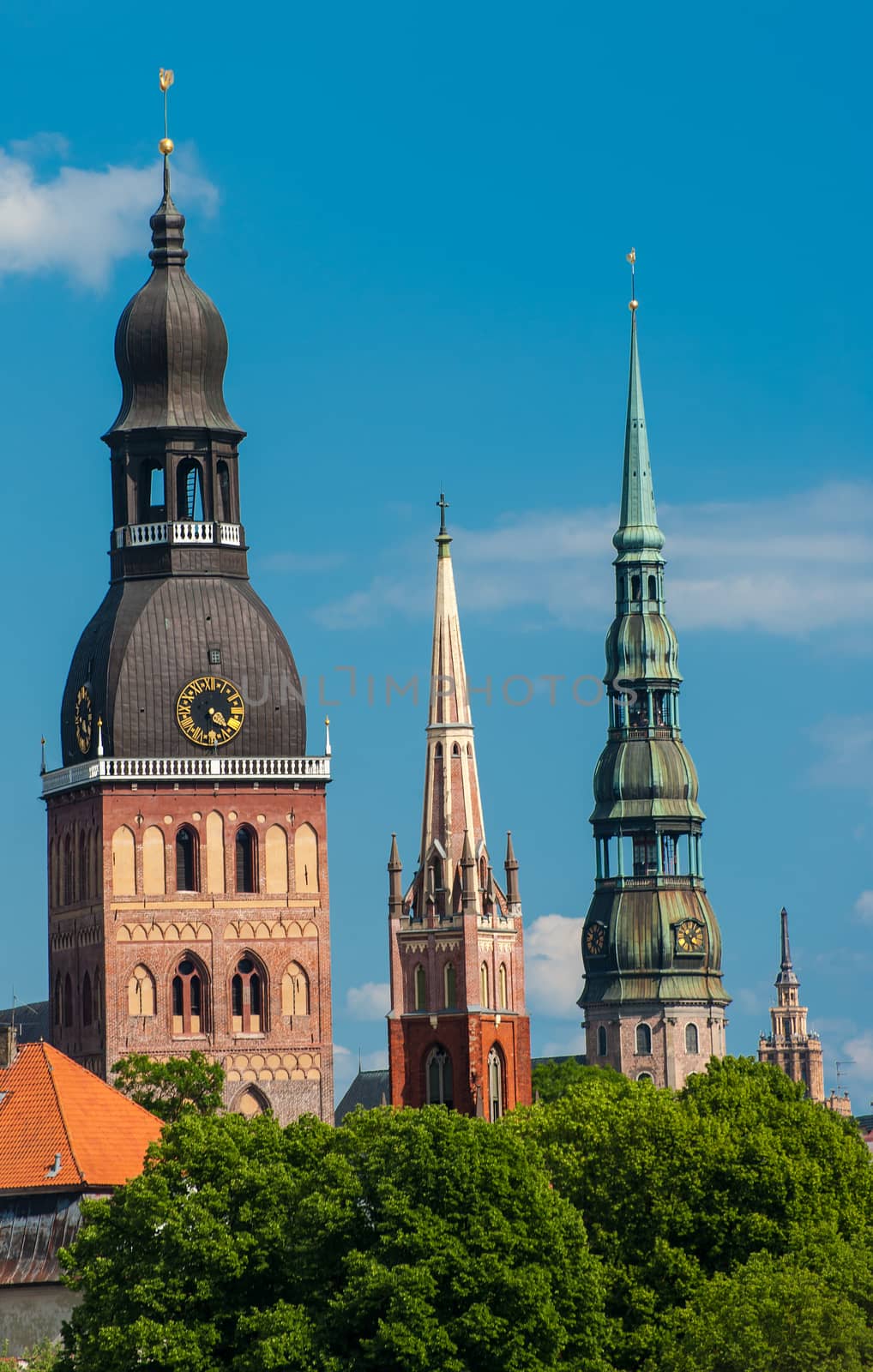 Towers of Riga seen in Riga. Three church towers in the picture are the Riga Dome cathedral,  St. Saviour's Church and St. Peter's church. On the right is Building of Academy of Sciences