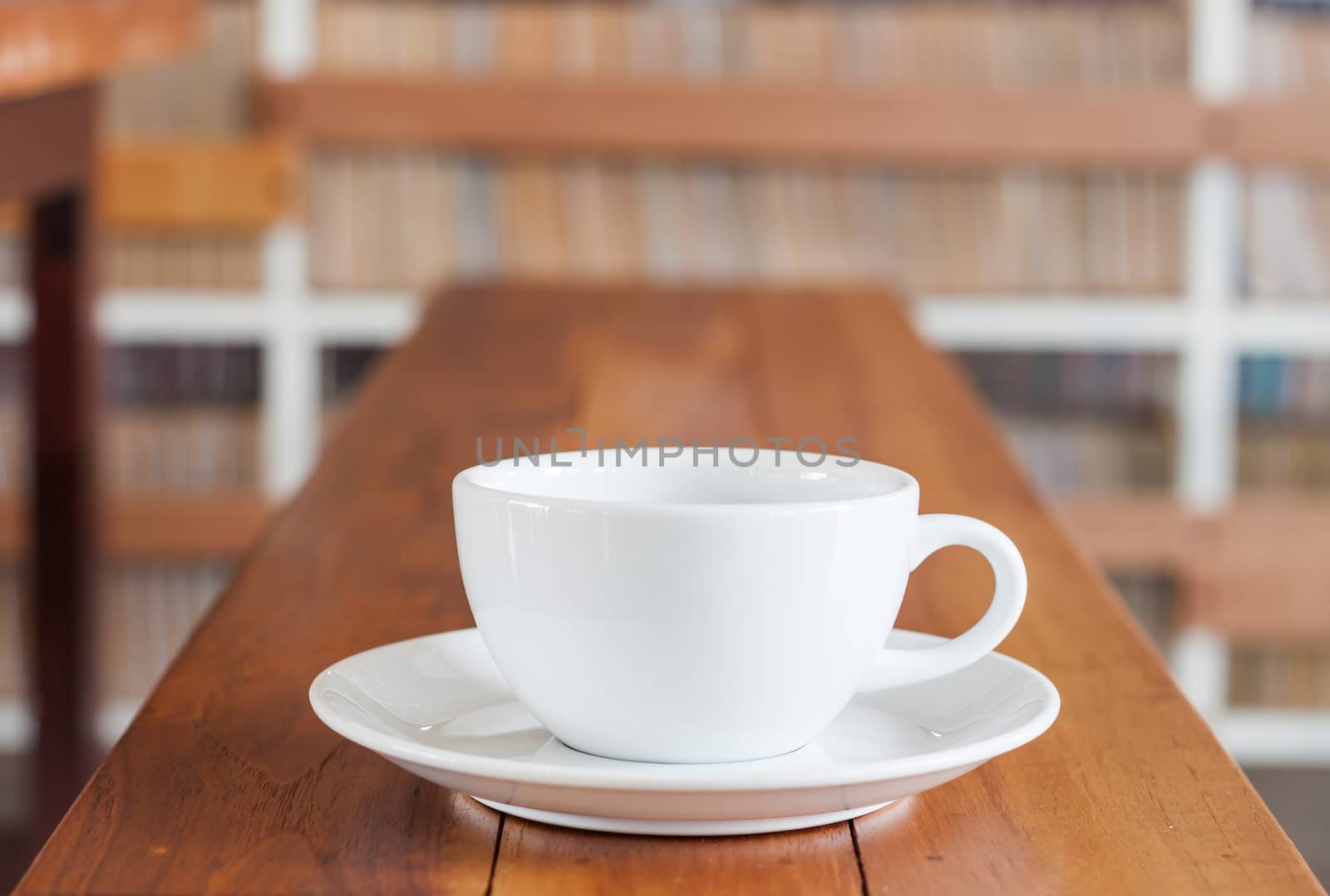 White coffee cup on wooden table by punsayaporn