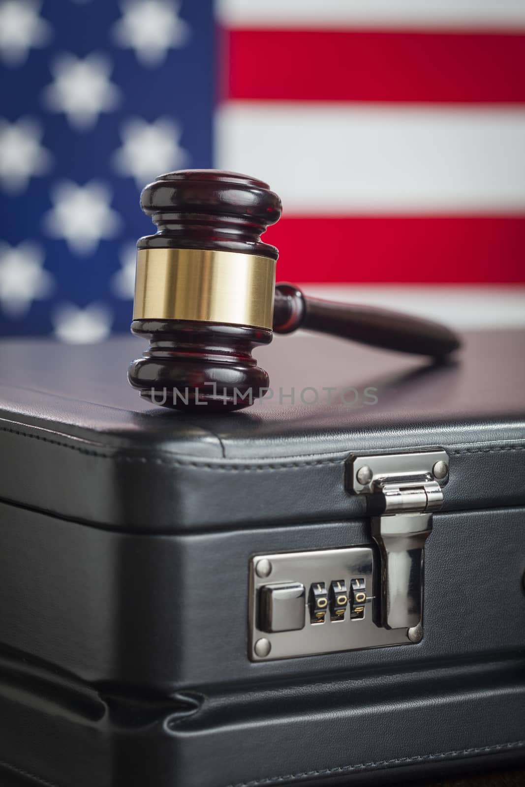 Leather Briefcase and Gavel Resting on Table with American Flag Behind.