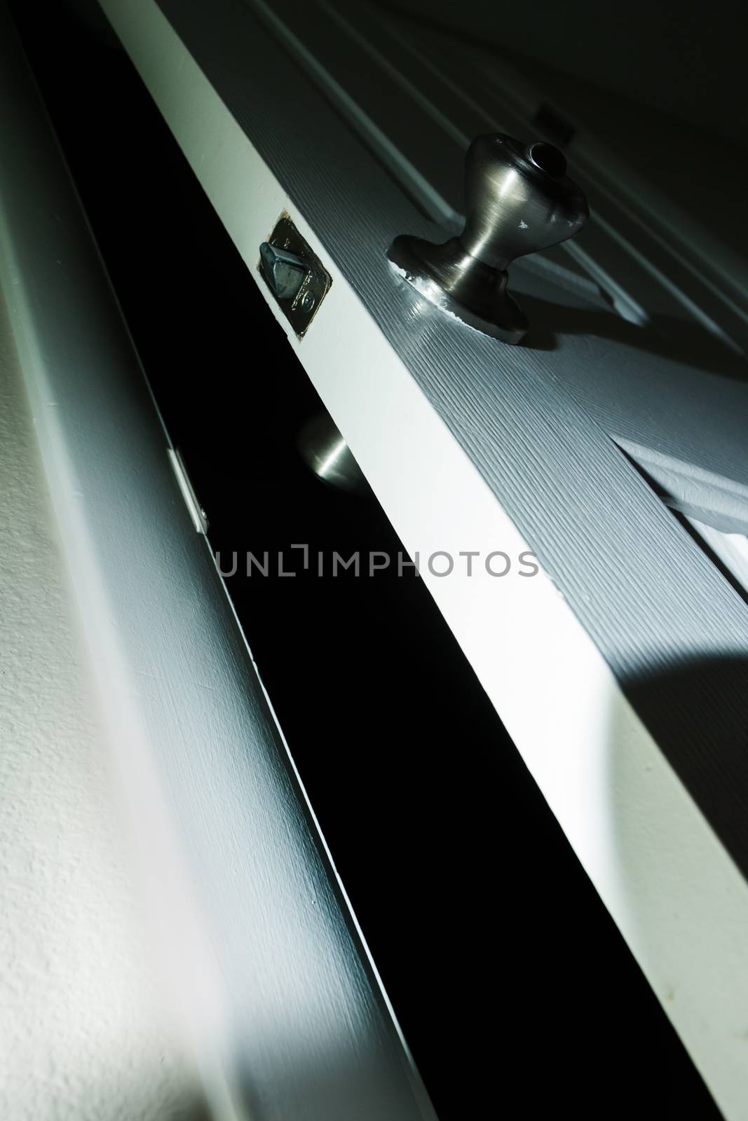 Door leading into darkness with a dramatic high contrast lighting