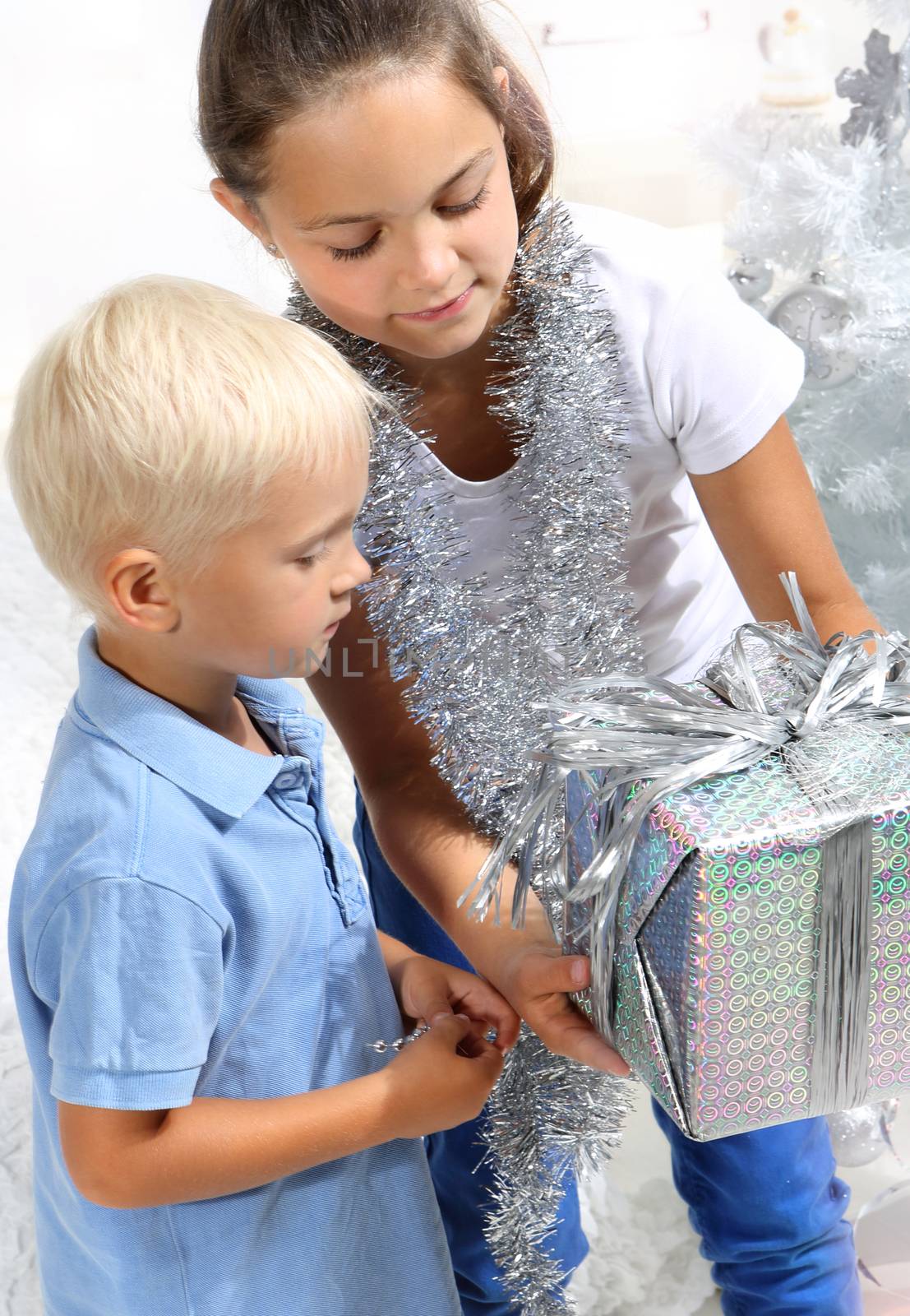 Sister gives her brother a Christmas gift by robert_przybysz