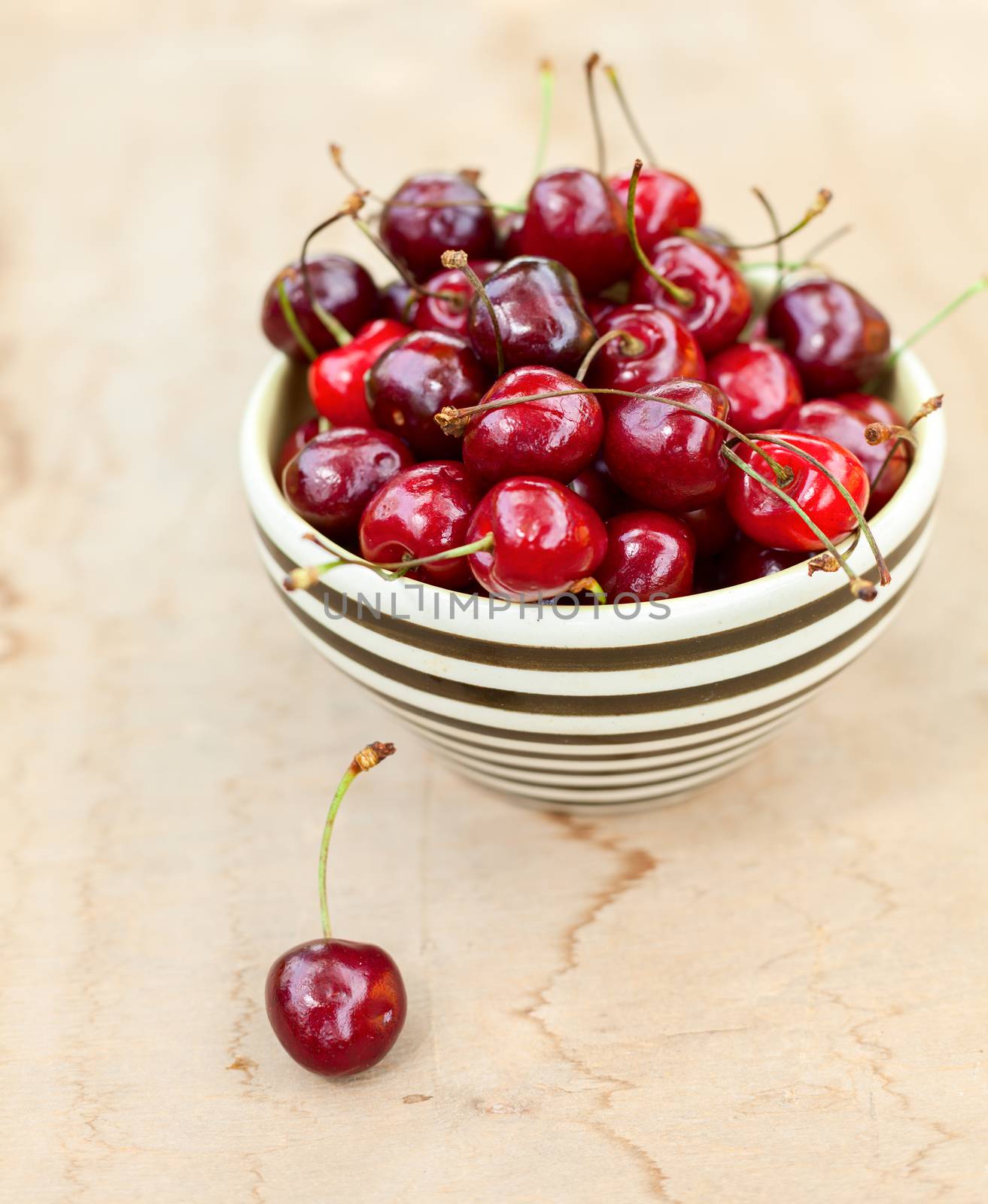 Bowl of sweet cherry on a table