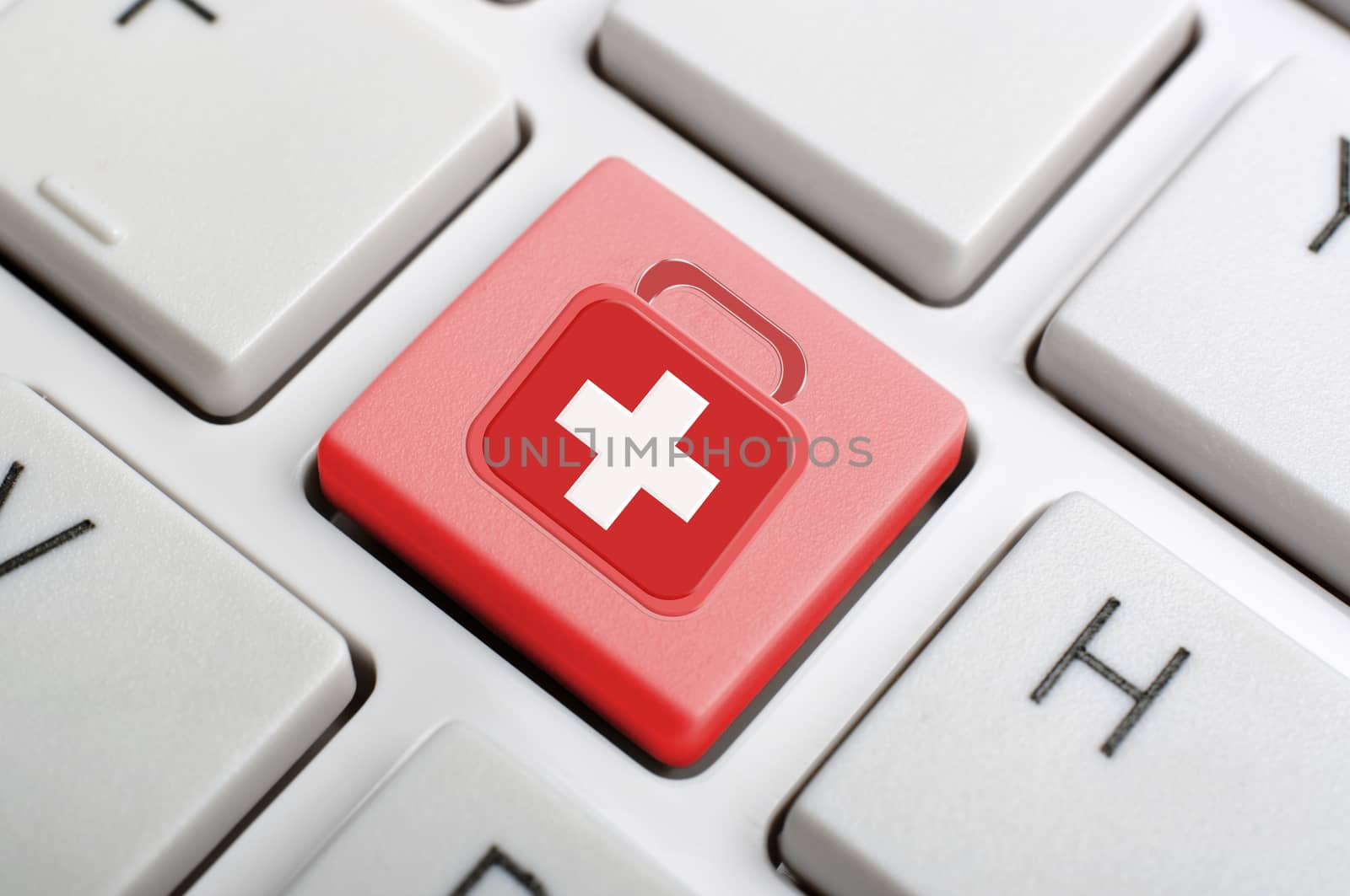 Coquitlam BC Canada - June 12, 2014 : Macro red first aid symbol key on white keyboard.  Abstract emergency concept on keyboard.