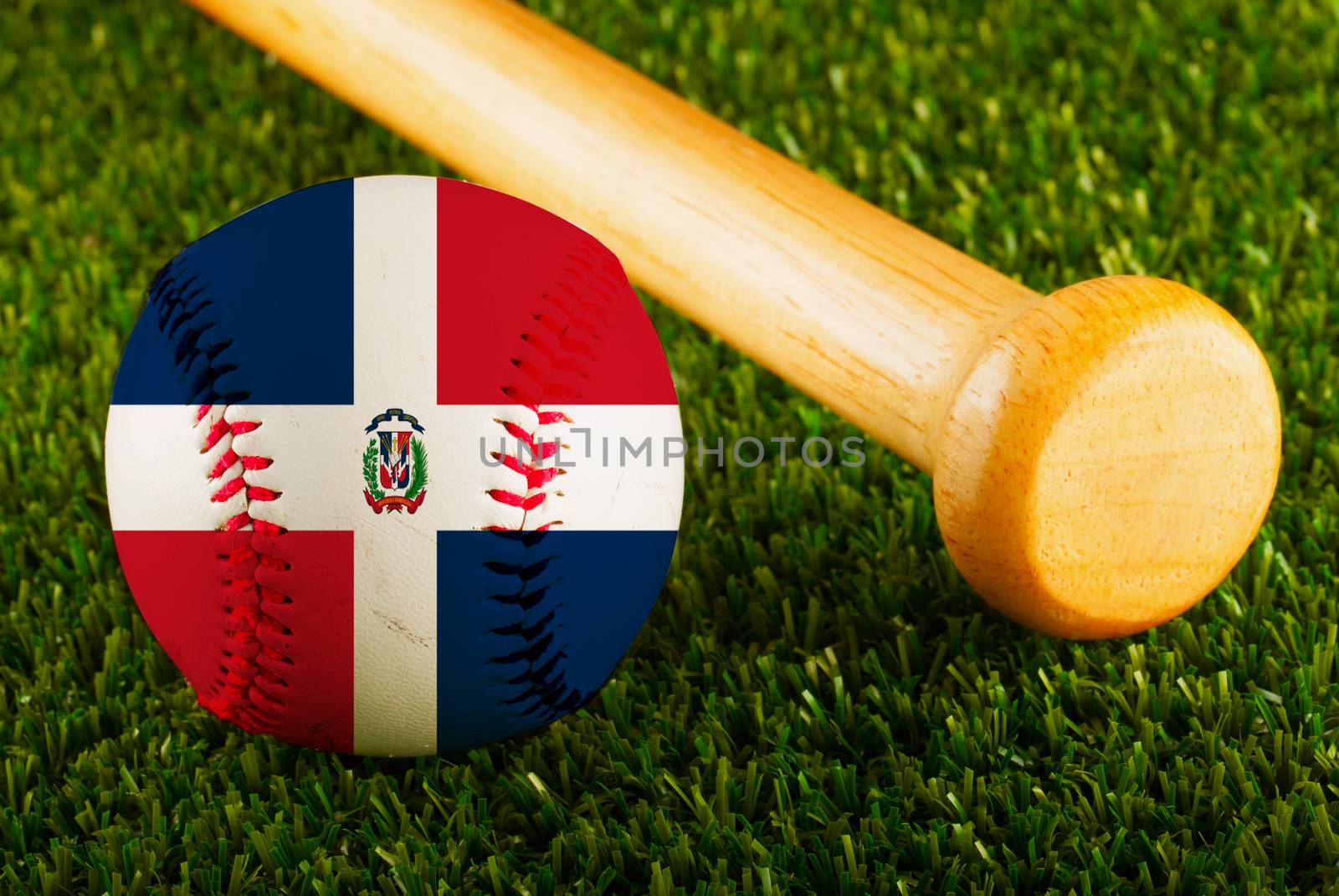 Baseball with Dominican Republic flag and bat over a background of green grass