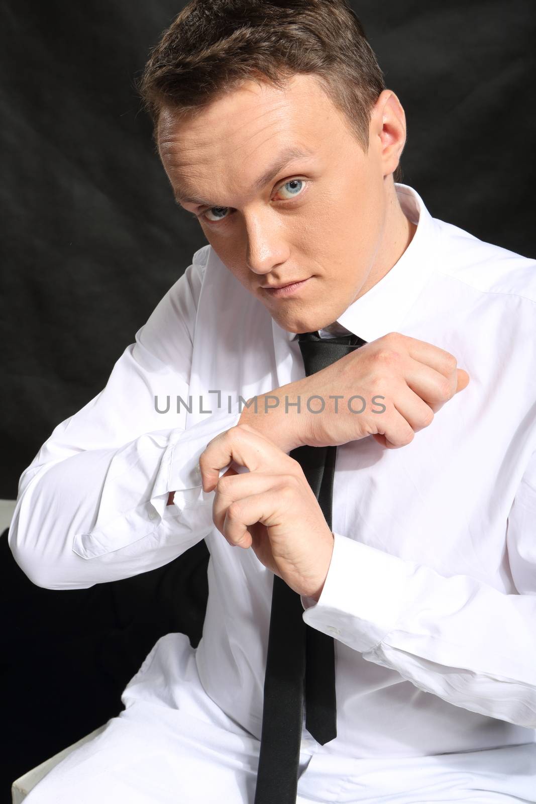 Portrait of smart young man zipped cuffs.