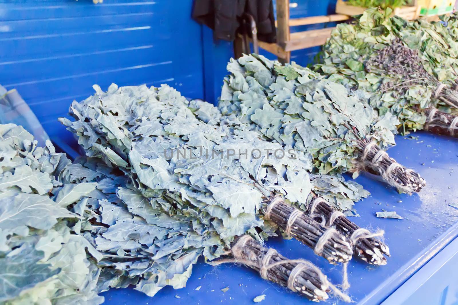 Photo of lot oak besoms in the market place