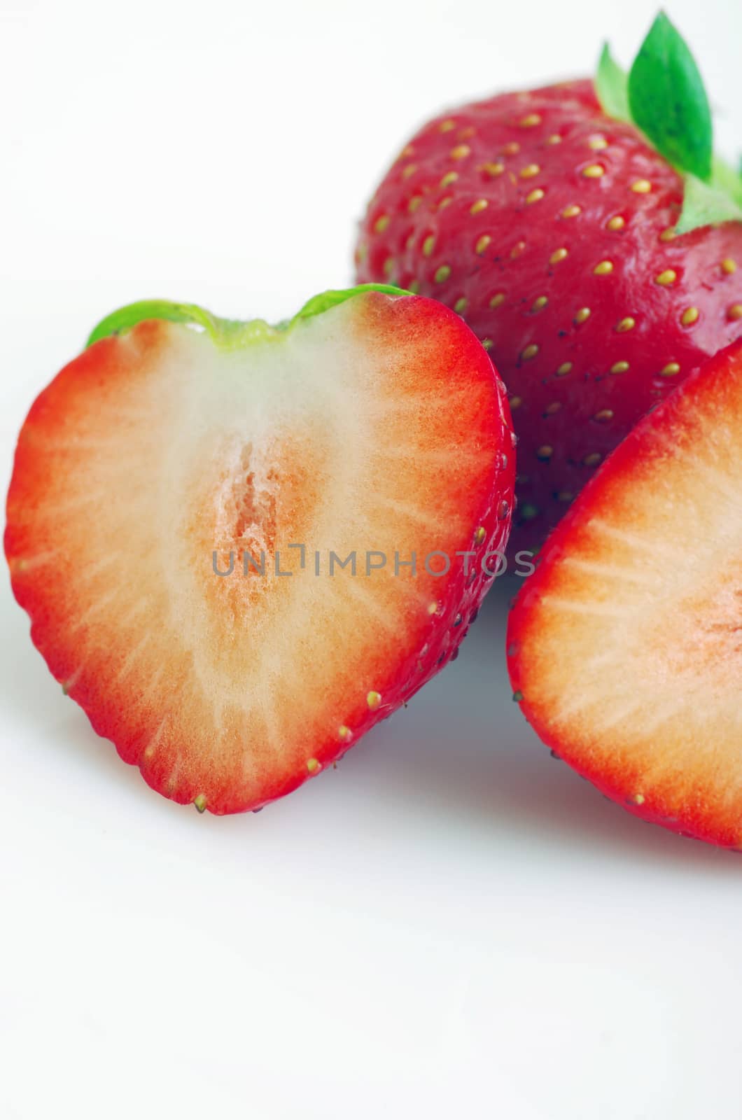 Healthy red strawberry fruit sliced isolated on the white background