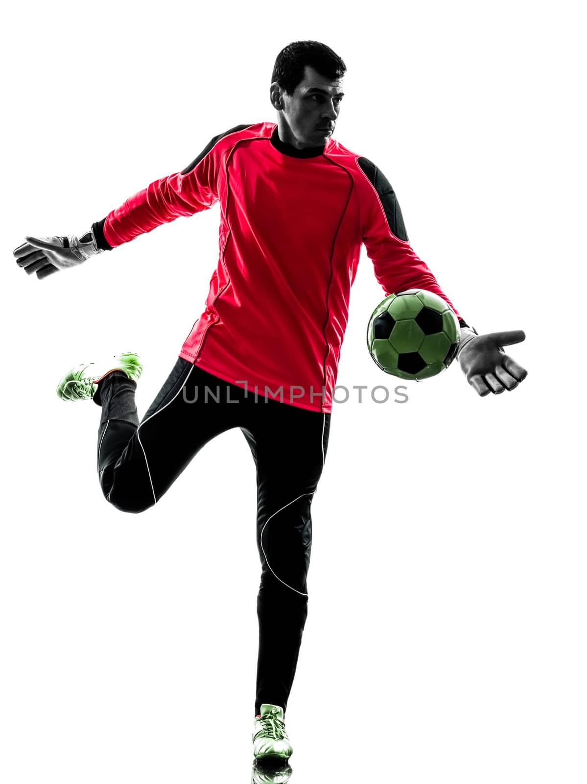 one caucasian soccer player goalkeeper man kicking ball in silhouette isolated white background