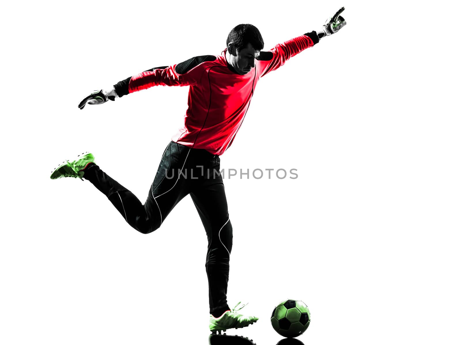 one caucasian soccer player goalkeeper man kicking ball in silhouette isolated white background