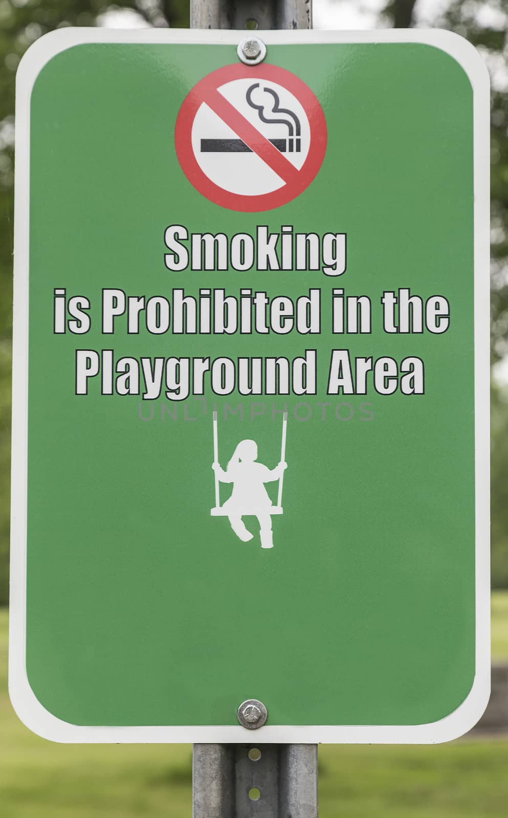 No smoking in the playground area sign. Icon of child swinging. 
