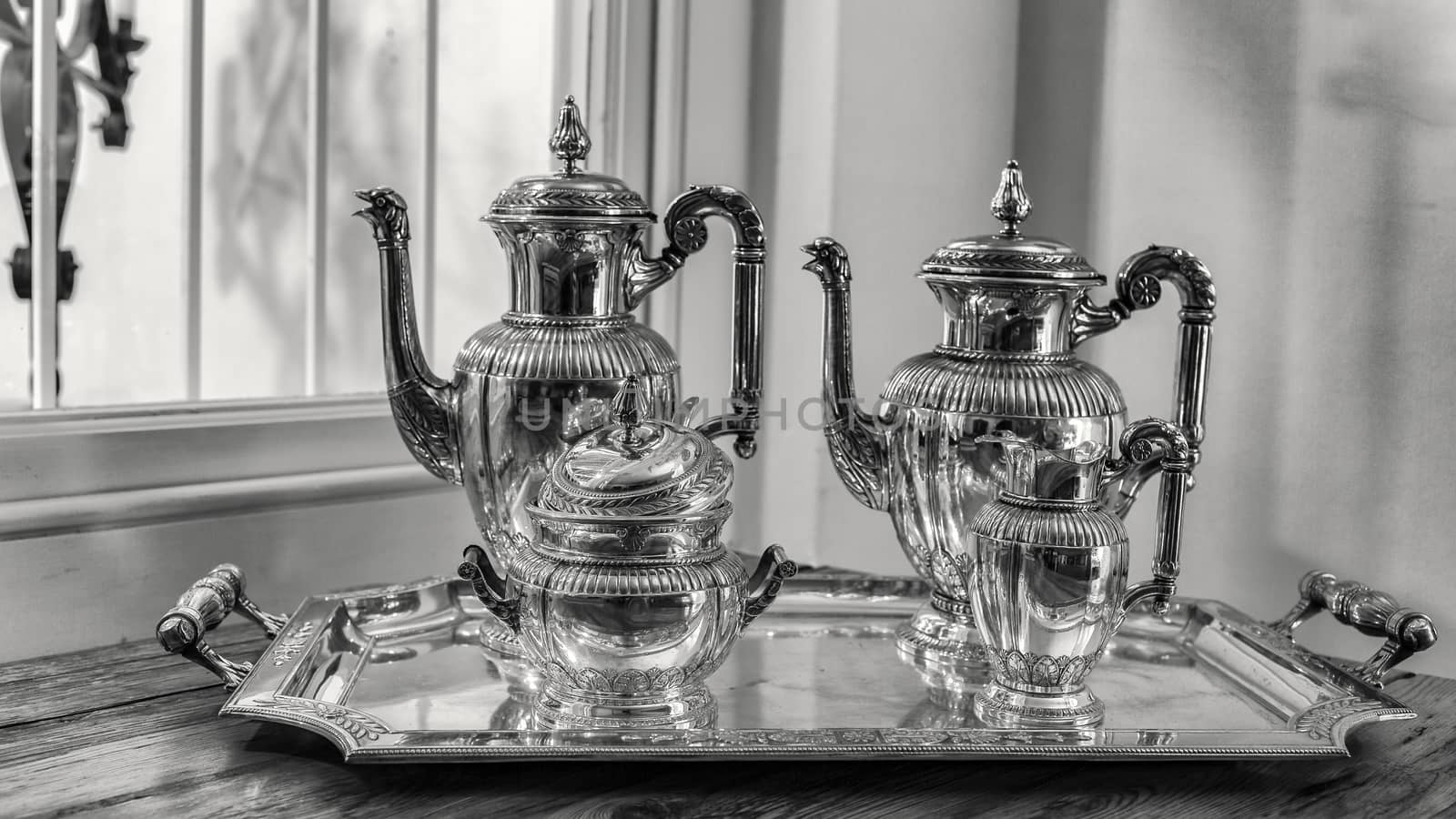 antique silver tea set with a two teapots, milk jug, sugar bowl, and a tray