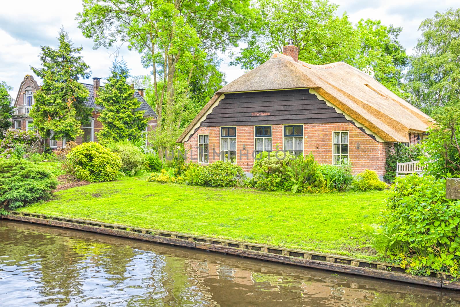 Typical Dutch houses and gardens in Giethoorn, The Netherlands by gianliguori