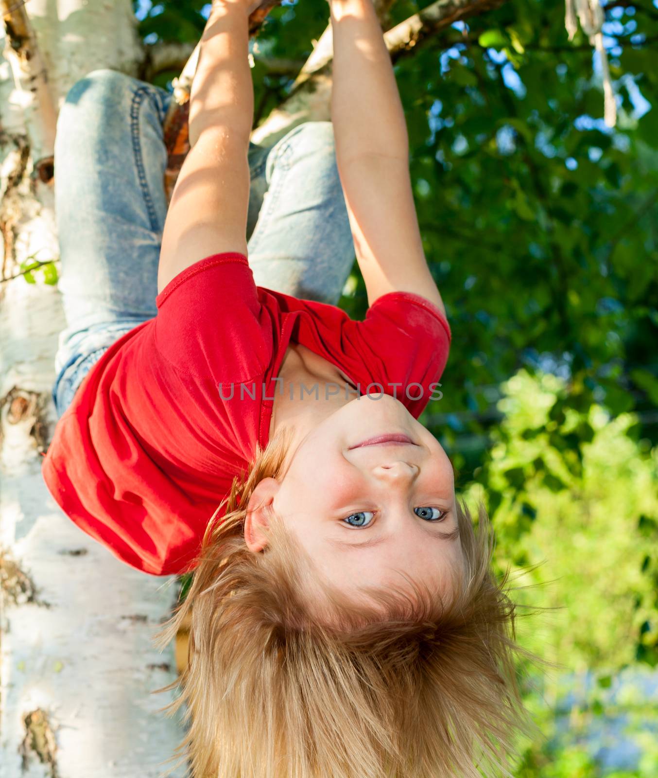 Child hanging from a tree branch by naumoid