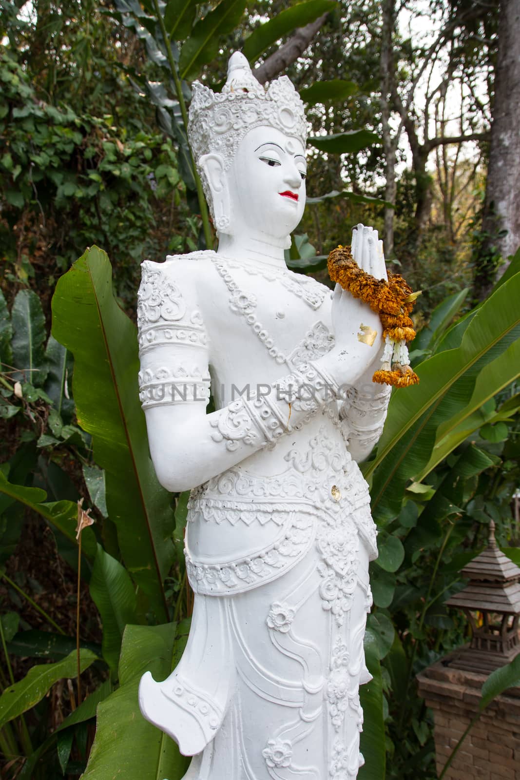Oriental god statue in Thailand with praying hand state